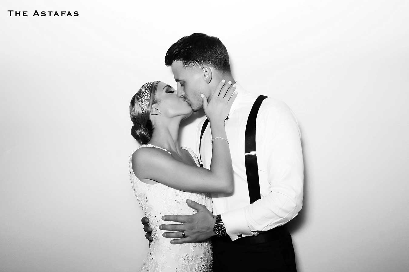 Glam Booth black and white photo of a couple kissing